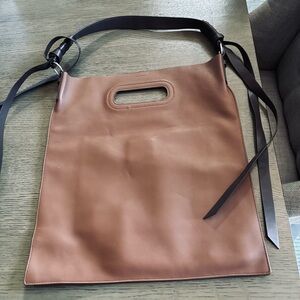 Brown Leather Tote with dark brown straps .
